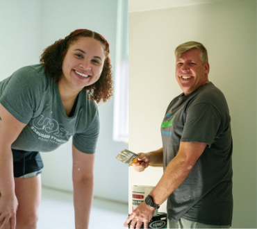A man and a woman painting a home.
