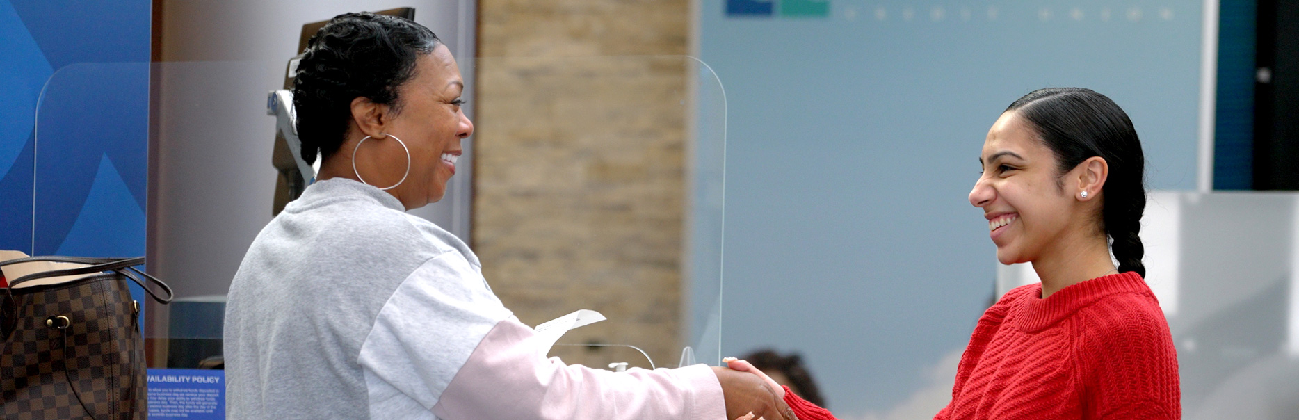 Two women exchanging a handshake.